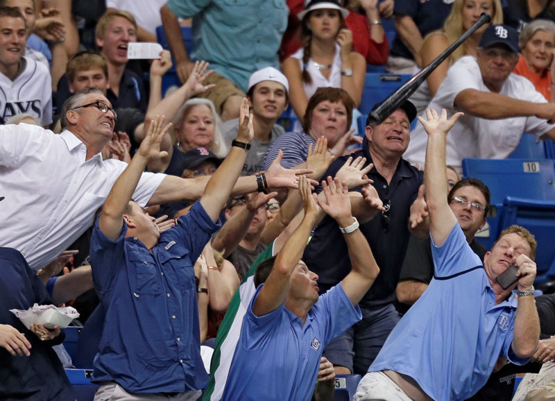 Fans scatter as Tampa Bay Rays' Jose Molina's bat goes flying into the seats during the second inning of a baseball game between the Rays and the Boston Red Sox on Wednesday, May 15, 2013, in St. Petersburg, Fla. (AP Photo/Chris O'Meara)