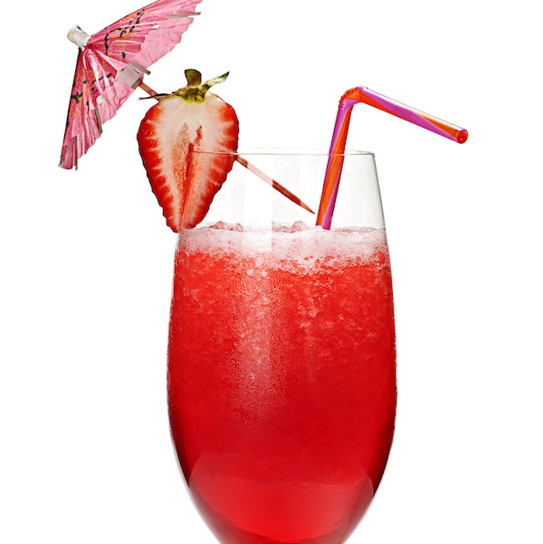 Strawberry daiquiri in glass isolated on white background with umbrella